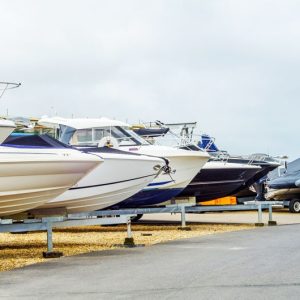 Boat on stand on the shore, close up on the part of the yacht, luxury ship, maintenance and parking place boat